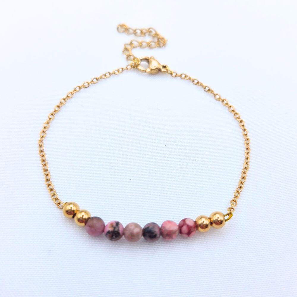 Bracelet fin en chaîne dorée avec perles de rhodonite roses et noires et billes d'acier inoxydable or.